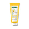 Klorane blonde hair care product with chamomile on a white background